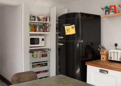 Compact kitchen with retro fridge and larder