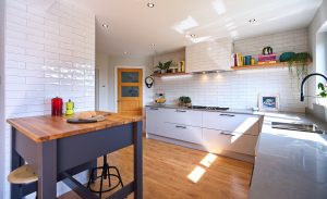 Modern kitchen with white tiles and grey worktops